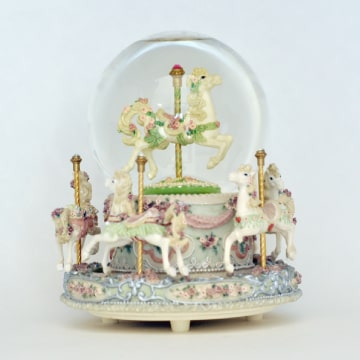 Music box with carousel and snowglobe.
