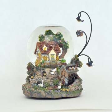 Music box with cottage in snowglobe.
